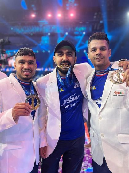 Celebrating with my fellow coaches and players, each of us with our winner's medals. This journey was a collaborative effort, and I'm proud of everyone involved.