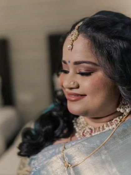 A serene reception look. This South Indian bride's pastel blue Kanjeevaram saree is paired with soft makeup and loose curls for an ethereal feel.