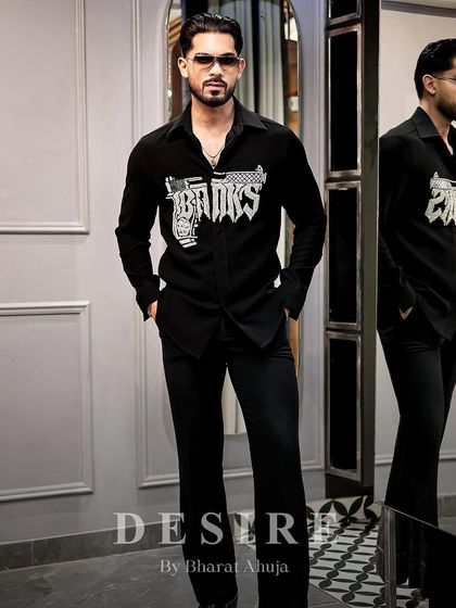 Walk in like you own the moment. The 'BAD BOYS' gun shirt, paired with black trousers, creates a look of effortless, rebellious cool.