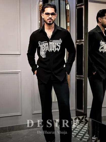 Walk in like you own the moment. The 'BAD BOYS' gun shirt, paired with black trousers, creates a look of effortless, rebellious cool.