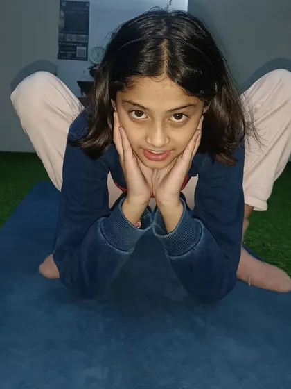 Another young student finding her own expression of Malasana. Yoga for kids is all about fun and creativity.