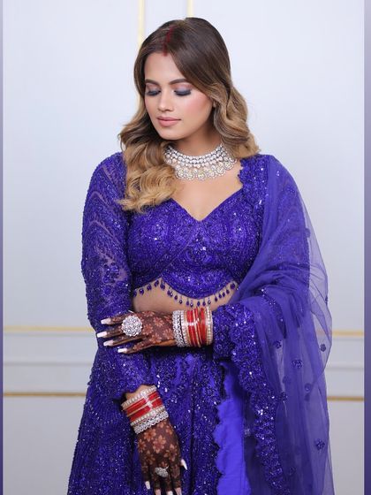A closer look at the details of this royal blue ensemble. The client's hennaed hands and diamond necklace are the perfect finishing touches to her glamorous look.