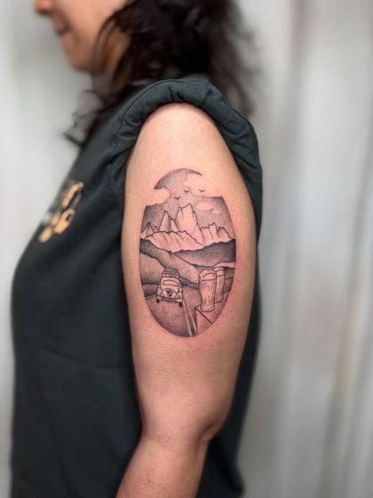 A view of the travel tattoo from a slight distance, showing its placement and size on the arm.