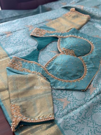 A padded bustier-style blouse in turquoise with minimal embroidery.