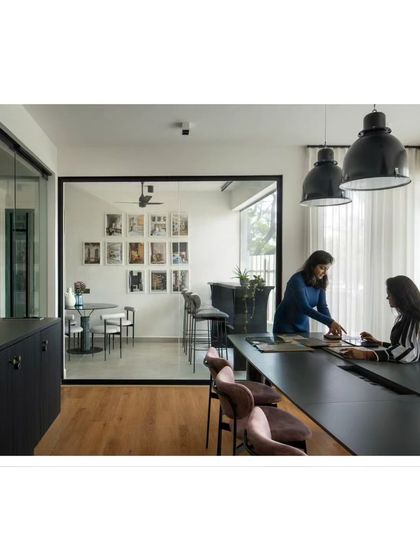 A glimpse of the magic happening at our conference table. This is where we collaborate, review plans, and work to find the 'extra' that elevates a design from ordinary to extraordinary.