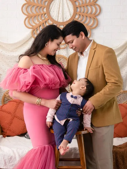 A candid, loving moment captured within our autumn-themed set. The family's interaction adds a layer of warmth to the already cozy atmosphere.