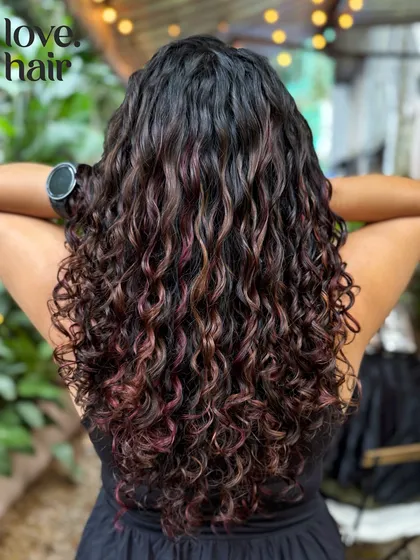 We call this our hot cocoa look. These warm, autumnal red and copper tones were created without any bleach, perfect for adding a cozy vibe to curly hair.