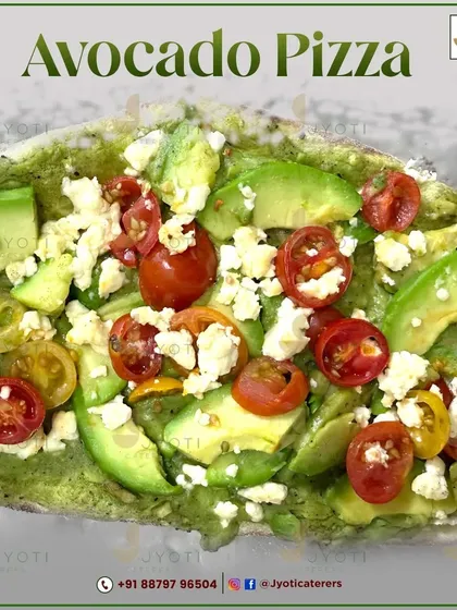 A fresh and healthy Avocado Pizza. This gourmet pizza is topped with a green pesto-like base, fresh avocado slices, cherry tomatoes, and crumbled cheese.