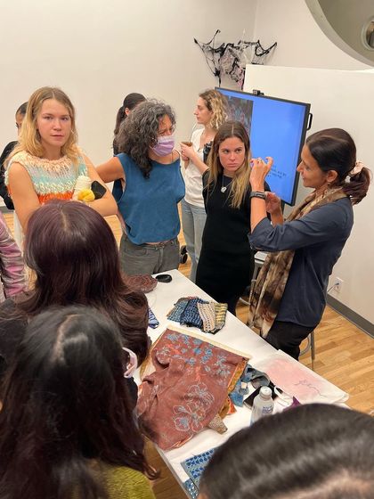 Students at Parsons School of Design in New York gather to look at our textiles and blocks. It's a moment of tangible connection between our Bangalore studio and the future of fashion.