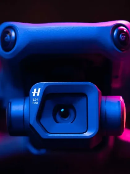 A dramatic close-up of the Hasselblad camera lens on our DJI Mavic 3 drone, highlighting the professional-grade imaging technology we employ.