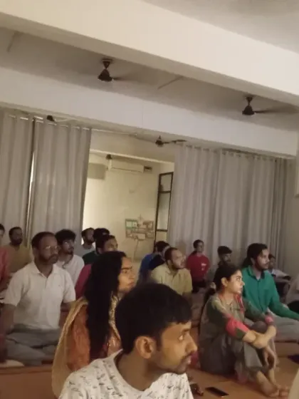 The community sits together during a Purnima gathering. The energy on these nights is noticeably different, making it a potent time for sadhana.