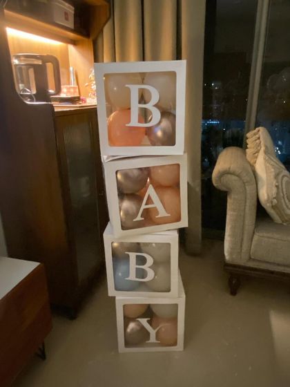 Simple decor can make a big impact. These stacked "BABY" blocks, filled with balloons in a chic metallic color scheme, are a perfect addition to any at-home baby welcome celebration, adding a modern and stylish touch.