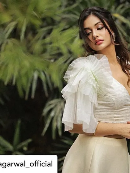 A beautiful, soft-focus shot of Divya Agarwal in our white ruffled blouse, highlighting the delicate and romantic feel of the organza sleeve.