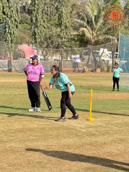A female player prepares to bowl during a PPL match, with her teammate ready at the wickets.