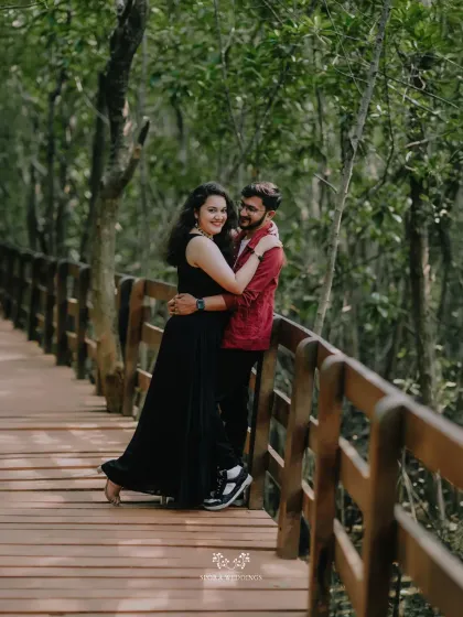 A romantic embrace on a wooden bridge, surrounded by the lush greenery of a mangrove forest.