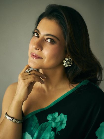A close-up on the jewelry and makeup that complements the floral saree, featuring statement earrings and a soft, glowing look.