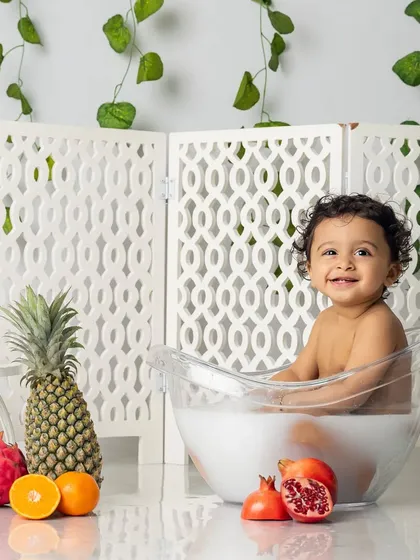 Time for a fruity splash. Our milk bath sessions are a fun, sensory experience for toddlers, resulting in photos filled with giggles and playful energy.
