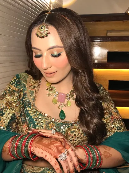 This shot highlights her mehndi-adorned hands and her statement rings.