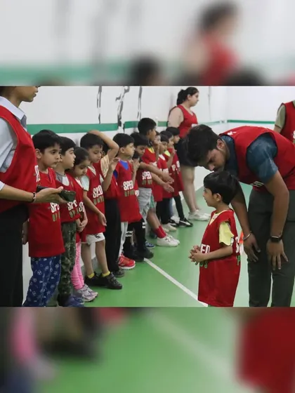 A coach having a quiet word with a young participant before a race, offering encouragement and advice.
