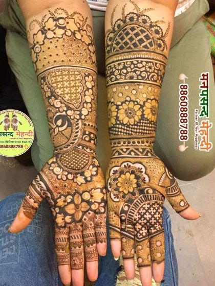 A lovely floral and peacock design that covers the full arm. The mix of bold flowers and geometric patterns creates a modern yet traditional feel.