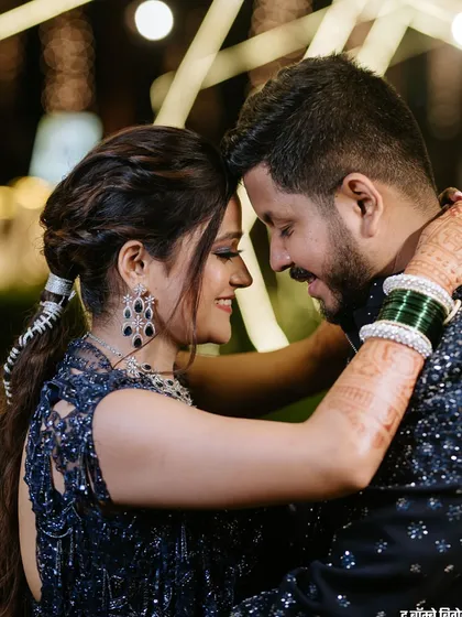 A romantic couple shot where the bride's elegant ponytail is visible, a perfect choice for a night of dancing and celebration.