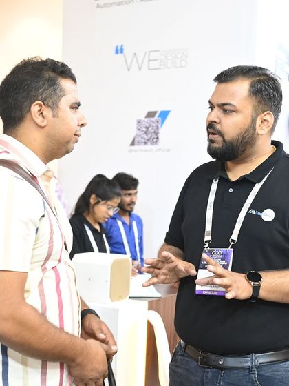 A member of our team in a detailed discussion with a visitor at our booth. We take the time to understand each person's unique needs and explain how our solutions can help.