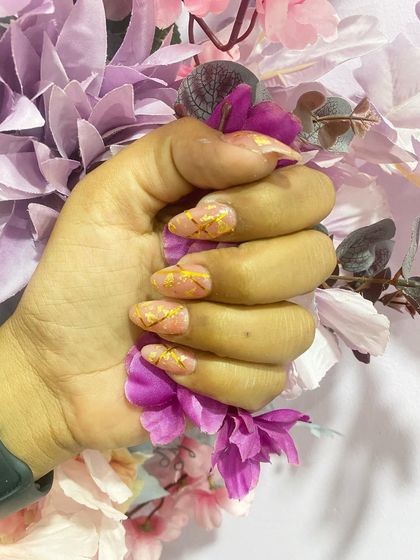 A close-up of a pink marble design with delicate gold lines, creating a kintsugi-like effect.