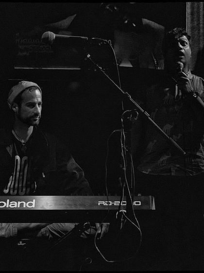 A black and white photo showing the interplay between the keyboardist and another musician at our Nublu show. These are the subtle, creative moments that make live music special.
