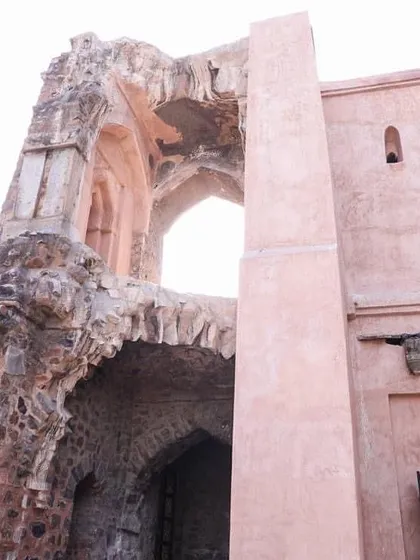 A sunlit view of the crumbling arch of Pir Ghaib. Its location on the ridge provided a strategic vantage point for hunting and observing the surrounding landscape.
