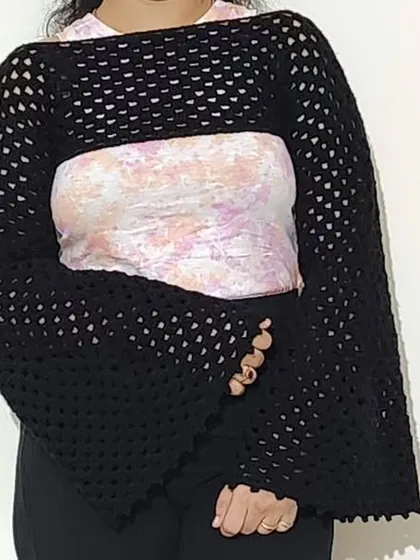 A full view of the Retro Shrug, showcasing its cropped fit and dramatic silhouette.