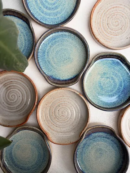 Our spoon rests are always in high demand. This overhead shot shows the beautiful variety of our studio-mixed glazes, including the drippy rutile and earthy shino finishes. Each one is a small piece of functional art for your kitchen.