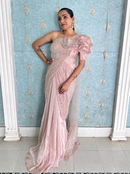 The full look of this modern pink draped saree. It's a chic and comfortable option for any wedding guest.