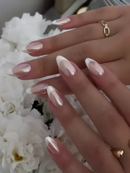 The timeless French manicure, elevated. This design features a soft, pearlescent chrome finish on the nail bed for a "glazed" effect, paired with crisp white tips on a classic almond shape. It is the definition of understated elegance.
