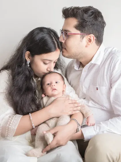 The first family portrait. The tenderness and awe in this photo are palpable as new parents cradle their newborn, a perfect start to their journey together.
