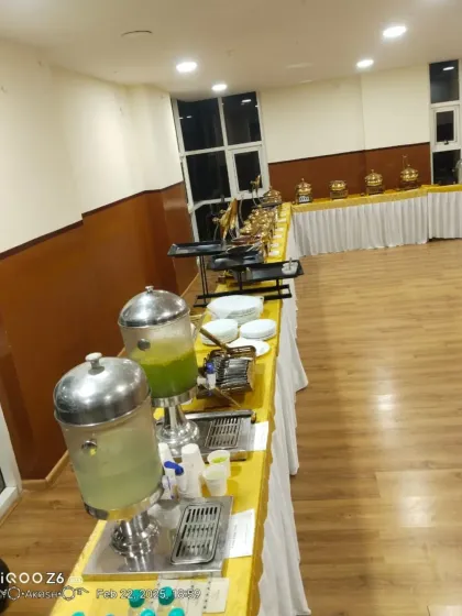 A beverage station with juice dispensers and neatly arranged cups, an essential part of any complete catering service.