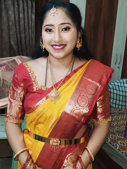 Ready for the ceremony! This photo showcases the full traditional ensemble, from the makeup and hair to the saree and accessories.