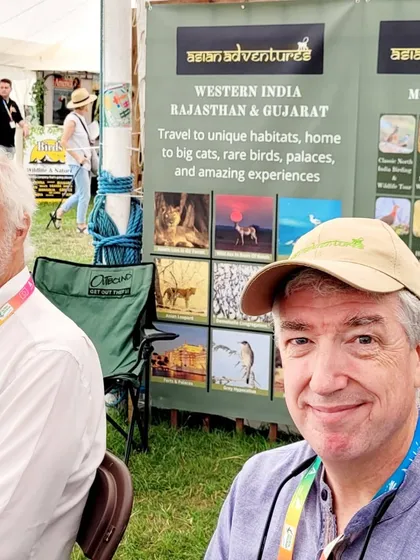 Two of our international partners and friends at our booth, which showcases our tours in Western India. The fair is a hub for collaboration and planning future wildlife journeys.