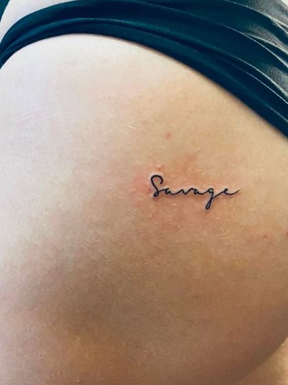 Another example of the popular "Savage" hip tattoo. It's a small tattoo with a big attitude.