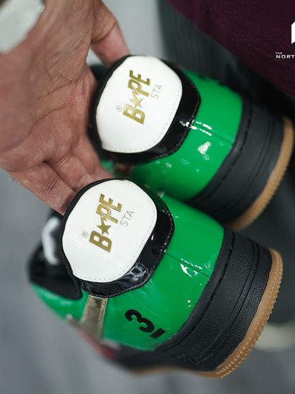 The heel tabs of the Bapesta Dubai edition, featuring the BAPE STA logo in gold foil.