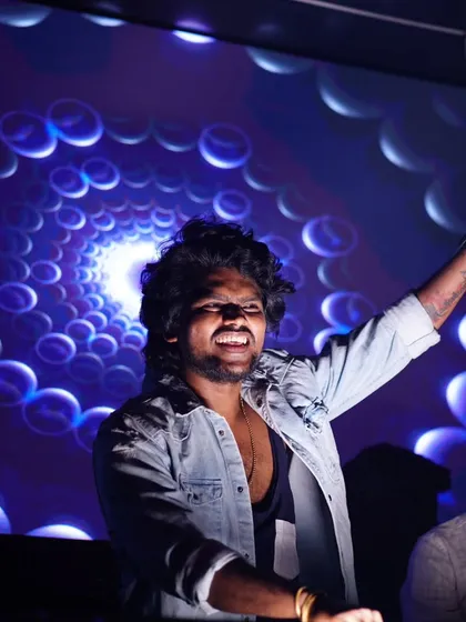 Spinning into the weekend with high energy and the latest beats. The hypnotic visuals behind me add to the immersive experience.