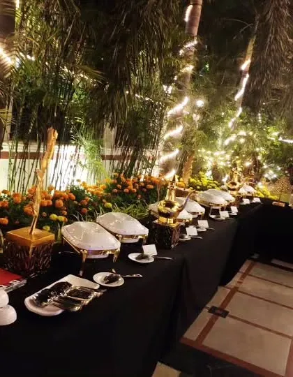 A wide shot of the beautiful night-time buffet, showing how the lighting and natural surroundings create a magical dining atmosphere.