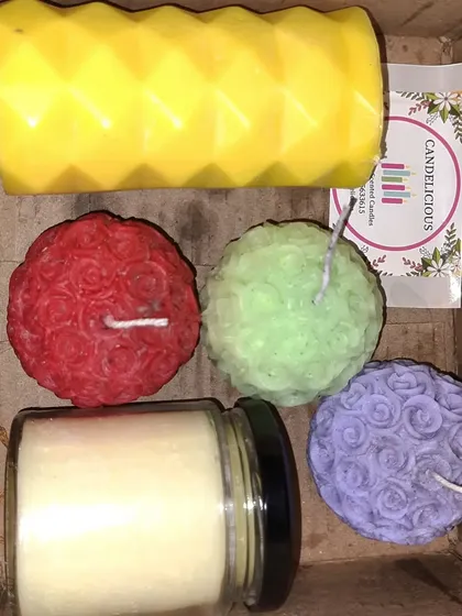 Can't decide on just one? This image shows a sample combo box with a variety of my candles, including a geometric pillar, scented ball candles, and a small jar candle. I can create a custom assortment just for you.