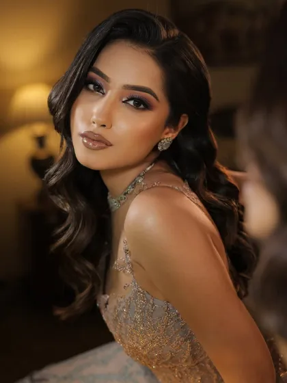 A close up portrait showcasing a soft retro wave look. The gentle S-shape waves frame the face beautifully, creating a glamorous and sophisticated style suitable for any evening event.