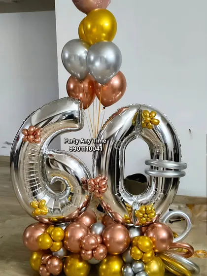 I design custom balloon bouquets for any milestone. This one for a 60th birthday uses large silver foil numbers, surrounded by a mix of rose gold, silver, and gold chrome balloons. These are great as a centerpiece or a surprise gift.