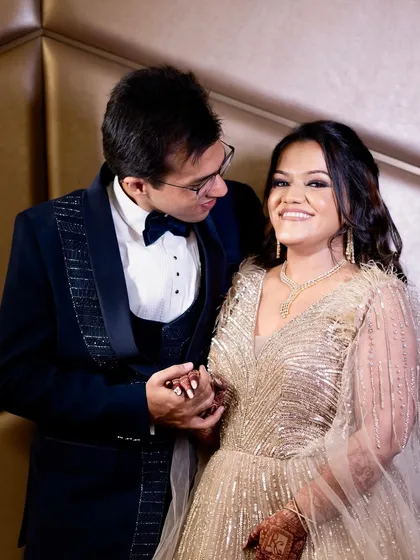 A romantic moment between the couple. Her makeup is soft and glowing, perfect for these cherished memories.
