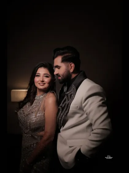 A classic, elegant portrait of the couple. The groom looks admiringly at his bride to be, capturing a moment of quiet connection during their engagement shoot.