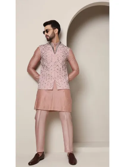 A confident pose in the 'Mystic Rose' bandi set. The rose copper hue and geometric embroidery make it a standout piece for any celebration.