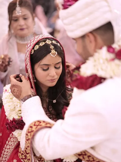 A close-up of the sacred Mangalsutra moment, a key ritual in Indian weddings. We ensure our photographers capture these intimate and significant traditions.