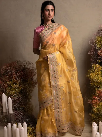 A stunning yellow organza saree with exquisite hand embroidery inspired by Sabyasachi. The sheer, lightweight fabric makes it perfect for daytime events and summer celebrations.