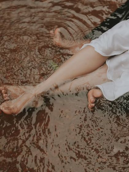 An abstract and artistic shot of a couple's feet in the rippling water. I love finding these unique perspectives during a creative couple session.